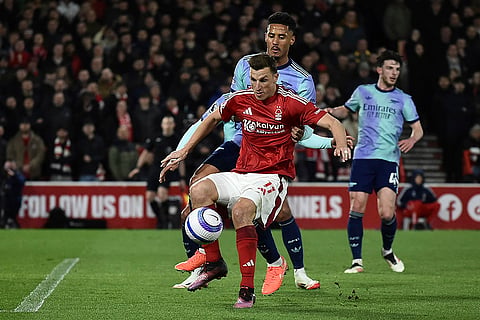 EPL 2024-25: Nottingham Forest's Chris Wood and Arsenal's William Saliba fight for the ball 