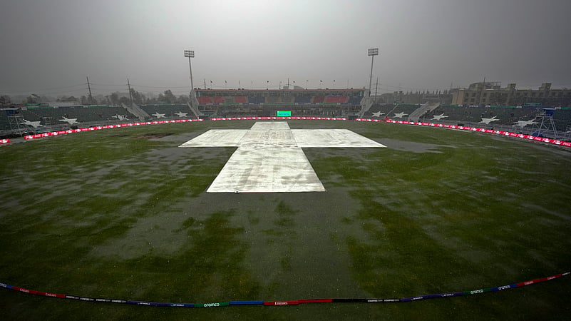 The pitch and ground covers as heavy rain fall before start. AP Photo