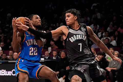 NBA 2024-25: Thunder's Cason Wallace (22) protects the ball from Nets' Killian Hayes