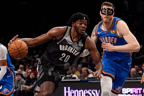 NBA 2024-25: Nets' Day'Ron Sharpe (20) drives past Thunder's Isaiah Hartenstein 