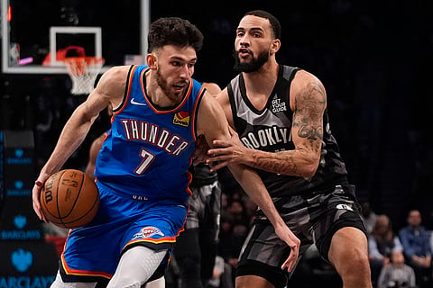 NBA 2024-25: Thunder's Chet Holmgren (7) drives past Nets' Tyrese Martin