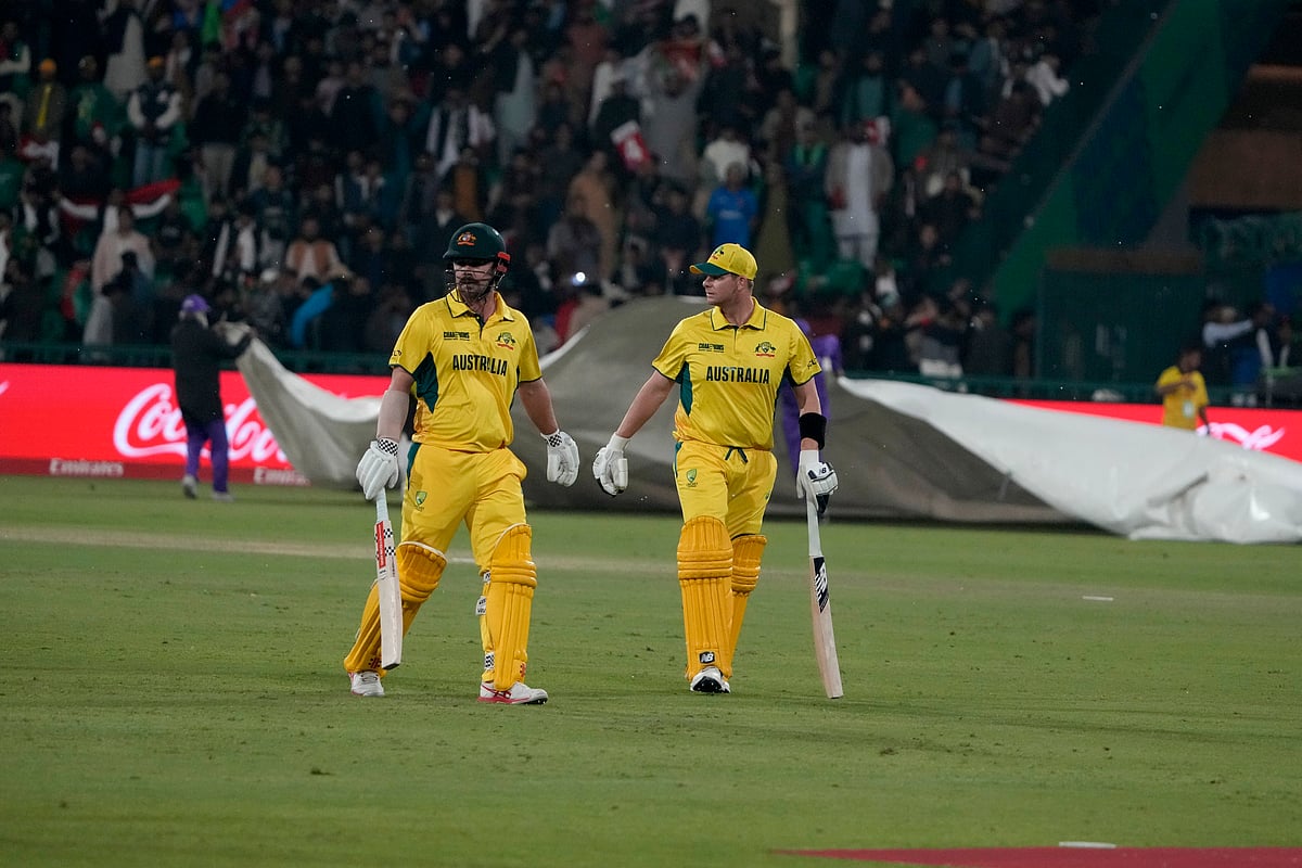  (AP Photo/K.M. Chaudary)

 : Australia's Steve Smith, right, and Travis Head walk off the field after rain stops the play of the ICC Champions Trophy cricket match between Australia and Afghanistan, in Lahore, Pakistan, Friday, Feb. 28, 2025.
