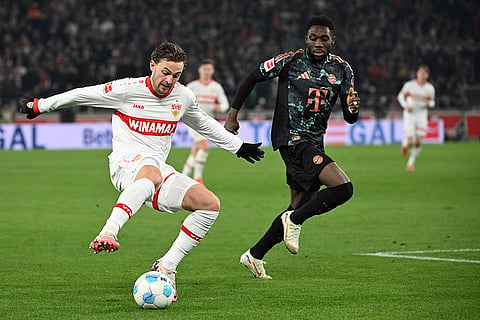 Bundesliga soccer 2024-25: Munich's Alphonso Davies and Stuttgart's Jacob Bruun Larsen in action