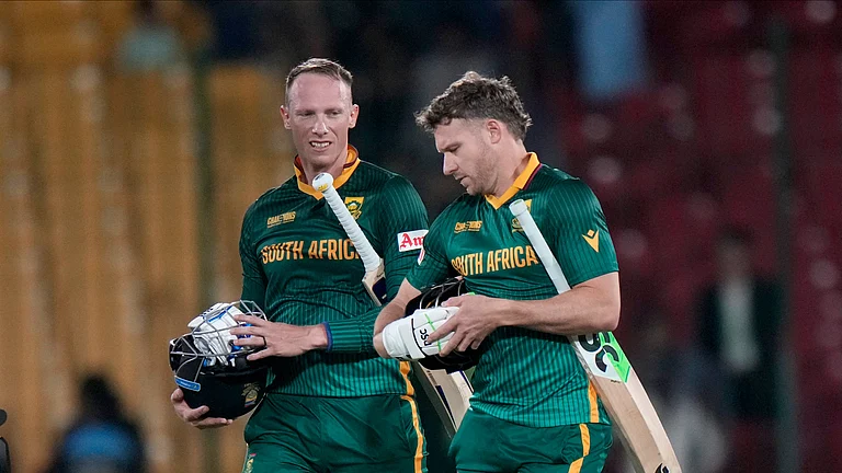 South Africa's David Miller, right, Rassie van der Dussen walks off the field on the end of the ICC Champions Trophy cricket match between England and South Africa, in Karachi. - AP Photo/Anjum Naveed