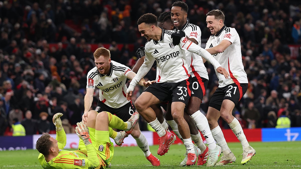 Fulhams players mob Bernd Leno after their win