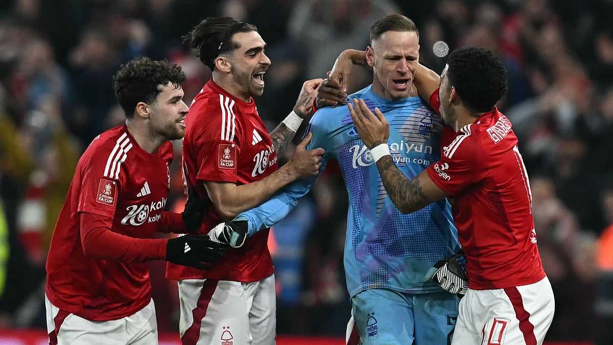 Nottingham Forest goalkeeper Matz Sels is mobbed by his team-mates after his penalty save. - null