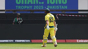 AP Photo/Christopher Pike : Australia's Travis Head walks off the field after losing his wicket during the ICC Champions Trophy semifinal cricket match between India and Australia at Dubai International Cricket Stadium in Dubai.