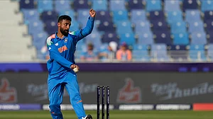 AP Photo/Altaf Qadri : India's Varun Chakravarthy bowls a delivery during the ICC Champions Trophy semifinal cricket match between India and Australia at Dubai International Cricket Stadium in Dubai.