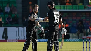 AP Photo/K.M Chaudary : New Zealand's Kane Williamson, left, celebrates with batting partner Daryl Mitchell after scoring a century during the ICC Champions Trophy semifinal cricket match between New Zealand and South Africa at Gaddafi Stadium in Lahore.