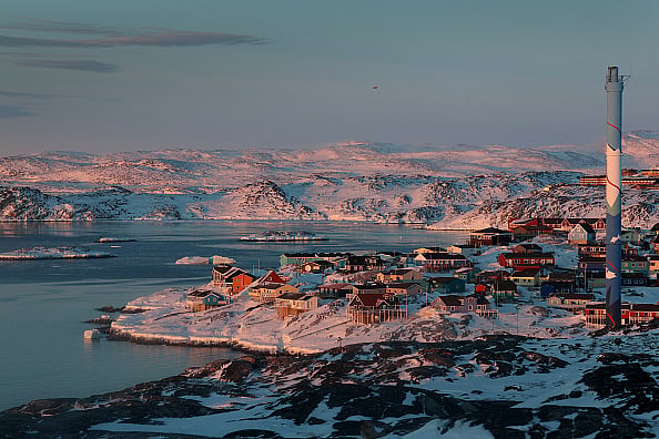 The village of Ilulissat, with a population of approximately 4000, sits among glaciers and snow-covered hills on March 03, 2025. - null