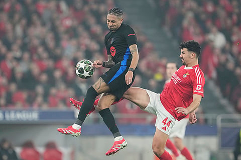 UCL round of 16 first leg, SLB vs FCB: Barcelona's Raphinha is challenged by Benfica's Tomas Araujo