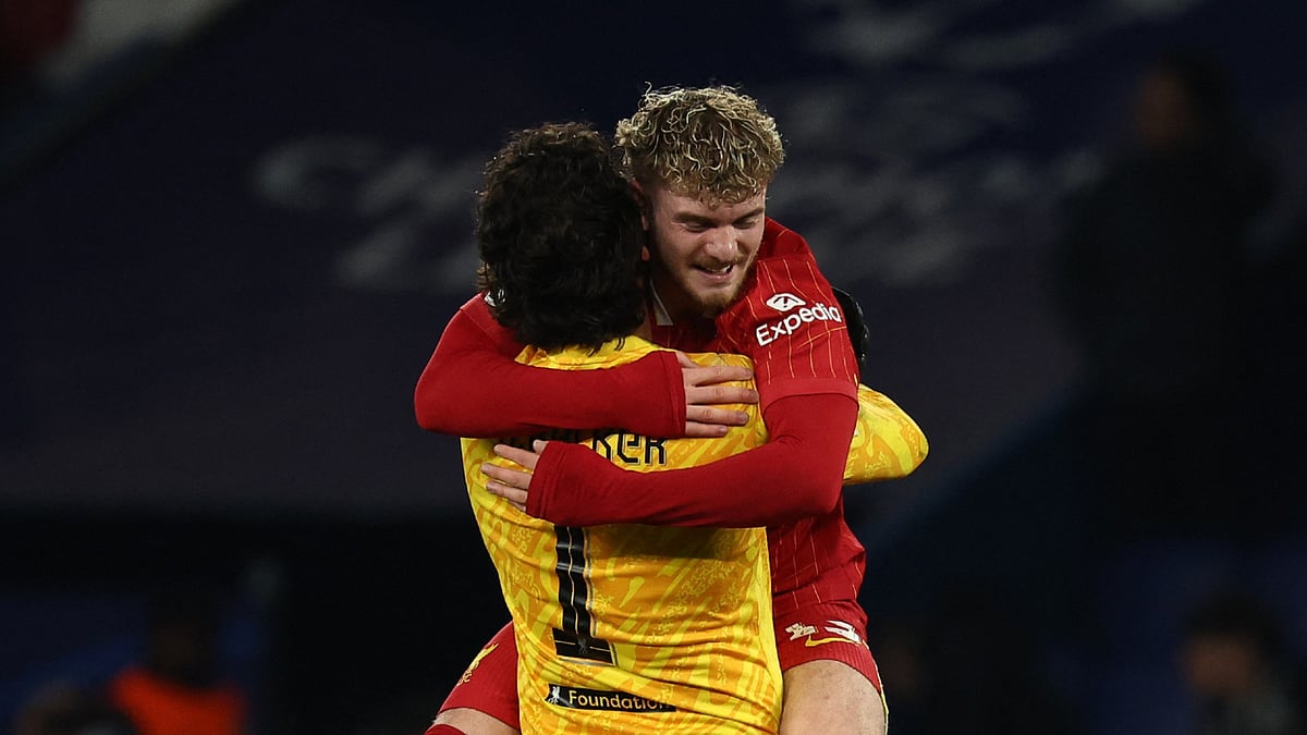 Harvey Elliott embraces Alisson.