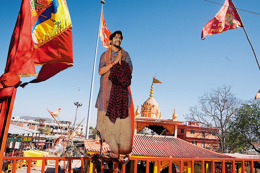 A larger than life cutout of Bageshwar Baba at the entrance of Bageshwar Dham temple 