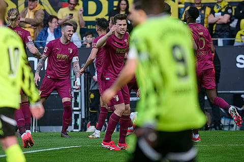 Bundesliga, Borussia Dortmund vs FC Augsburg: Augsburg's Jeffrey Gouweleeuw, left, celebrates after scoring a goal