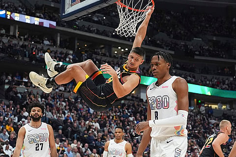 NBA 2024-25: Phoenix Suns guard Grayson Allen, center, hangs from the rim