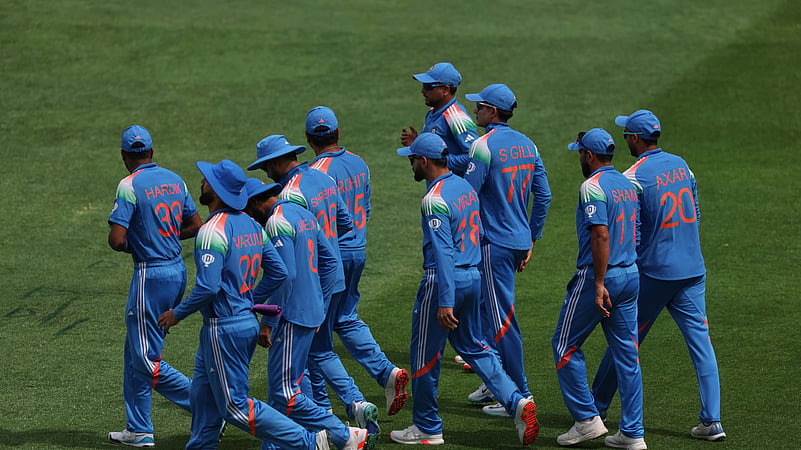 Indian players walk into the field during the ICC CT. AP