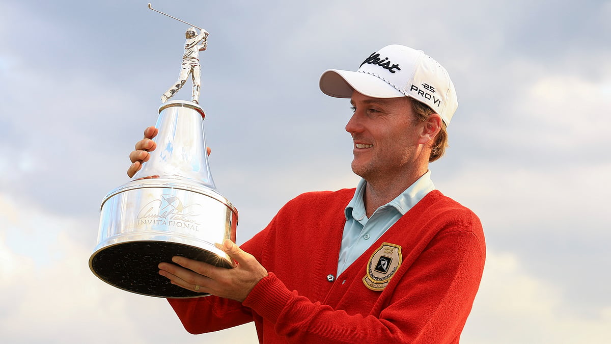 Russell Henley poses with the trophy after winning the Arnold Palmer Invitational