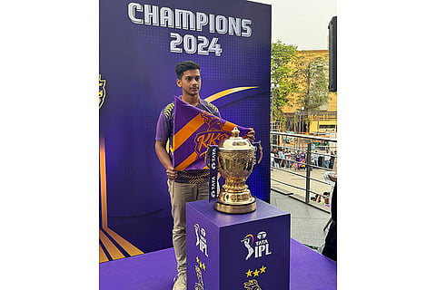 A Kolkata Knight Riders supporter celebrates with the IPL trophy in Durgapur