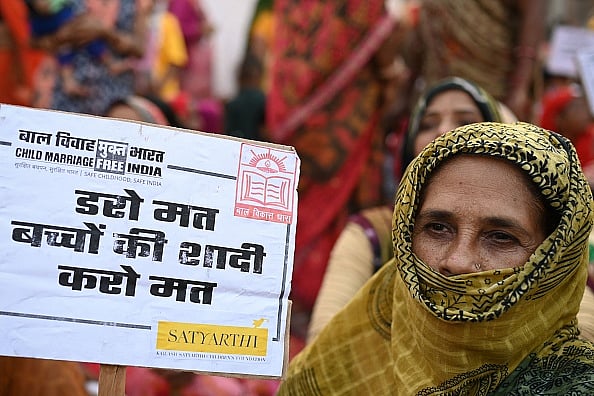 Women display placards during the launch of the child marriage free India campaign  - Getty Images 