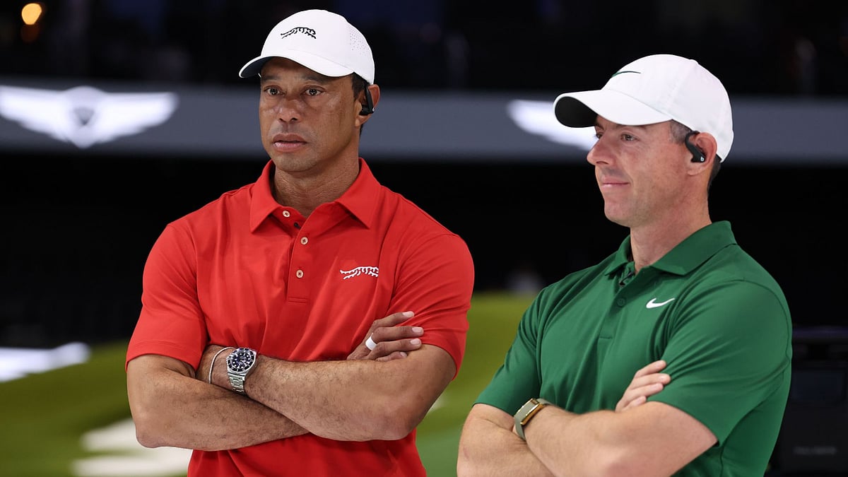 McIlroy (right) empathises with Woods after his latest injury setback - null