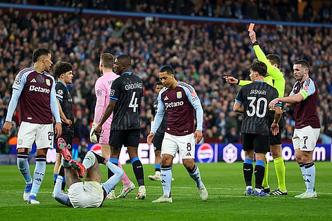 UCL 2024-25, Aston Villa vs Club Brugge: Referee Daniel Siebert shows a red card to Brugge's Kyriani Sabbe