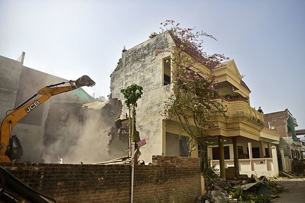 A bulldozer is being used to demolish the illegal structures in Allahabad