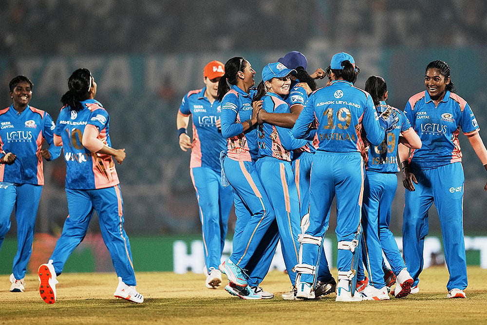 | Photo: PTI/Kunal Patil : WPL 2025 play-off, MI vs GG: Mumbai Indians' players celebrate the wicket of Gujarat Giants' batter Beth Mooney 
