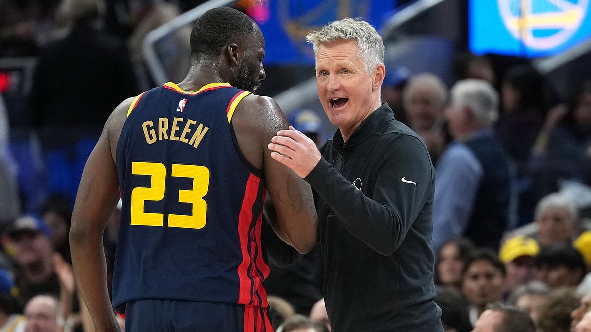 Head coach Steve Kerr of the Golden State Warriors talks with his player Draymond Green #23 during a break in the action against the Sacramento Kings in the fourth quarter at Chase Center on March 13, 2025 in San Francisco, California.