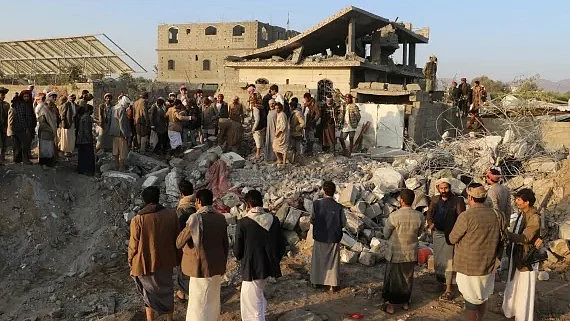 People gather at the site of a US strike in Yemen