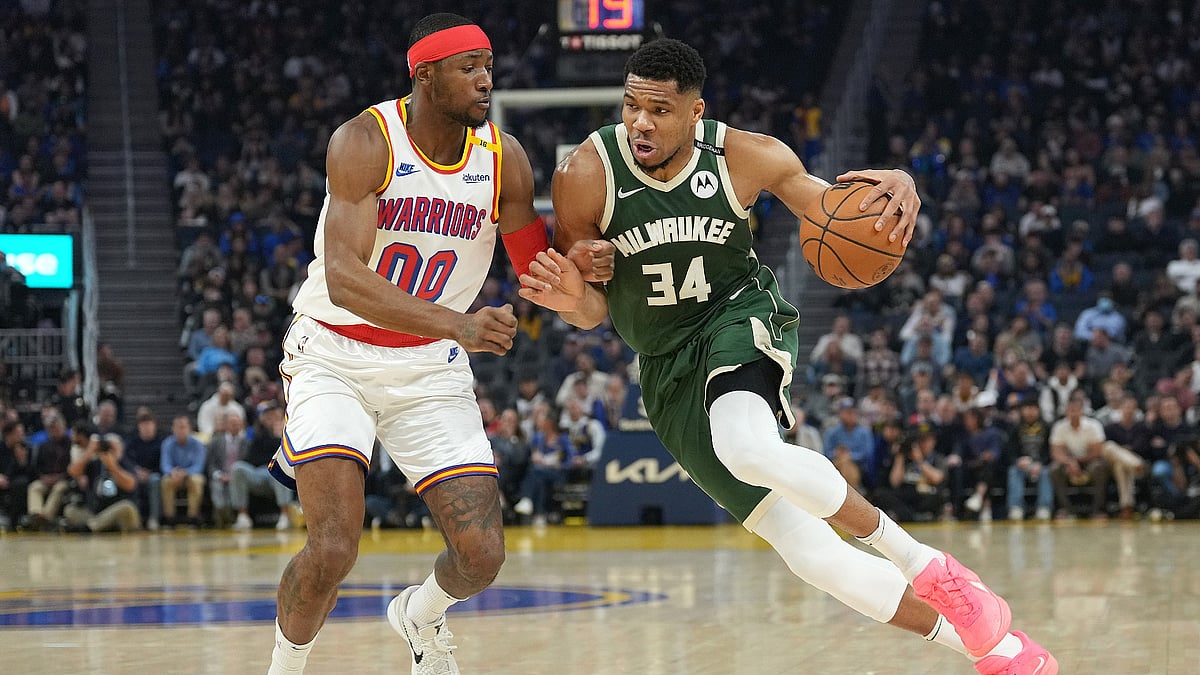 Giannis Antetokounmpo #34 of the Milwaukee Bucks drives against Jonathan Kuminga #00 of the Golden State Warriors during the first half at Chase Center on March 18, 2025 in San Francisco, California.