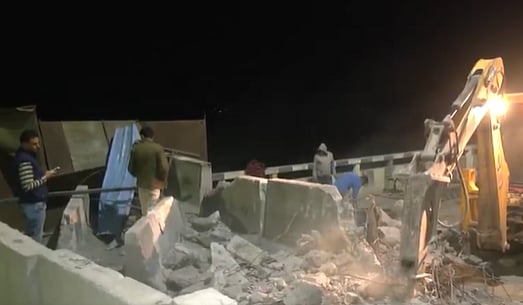 X/ANI Screengrab : Police used bulldozers to remove concrete barricades erected at Haryana - Punjab Shambhu Borde
