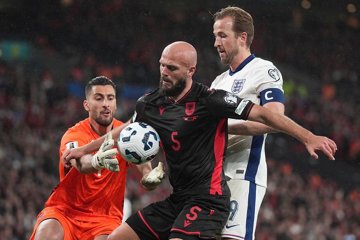 Albania goalkeeper Thomas Strakosha saves on an attempt to score by England's Harry Kane, right, during a World Cup qualifying soccer match between England and Albania at Wembley stadium in London, Friday, March 21, 2025. (