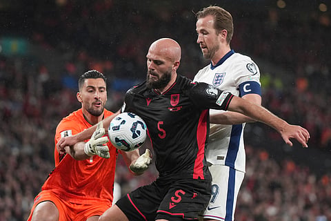Albania goalkeeper Thomas Strakosha saves on an attempt to score by England's Harry Kane, right, during a World Cup qualifying soccer match between England and Albania at Wembley stadium in London, Friday, March 21, 2025. (
