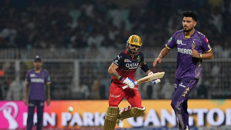 Royal Challengers Bengalurus Virat Kohli, center, runs between the wicket. AP