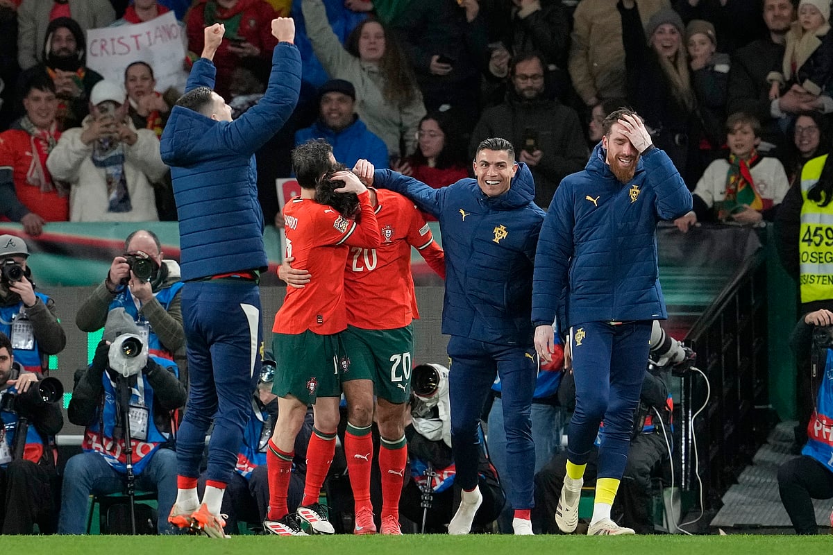  (AP Photo/Armando Franca) : Portugal's Francisco Trincao, center, celebrates with teammates after scoring his side's fourth goal during the UEFA Nations League soccer match between Portugal and Denmark, at the Jose Alvalade Stadium in Lisbon, Sunday, March 23, 2025.