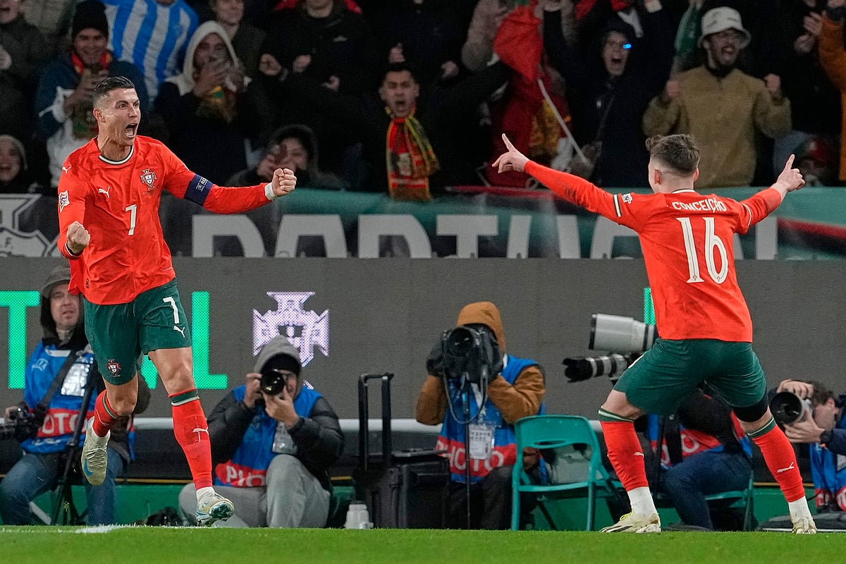 Portugal's Cristiano Ronaldo, left, celebrates after scoring his side's second goal during the UEFA Nations League soccer match between Portugal and Denmark, at the Jose Alvalade Stadium in Lisbon, Sunday, March 23, 2025. 