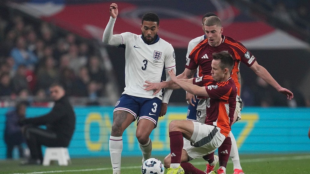 AP : Reece James, left, challenges for the ball with Latvia's Janis Ikaunieks and Latvia's Vladislavs Gutkovskis during a World Cup qualifier match.