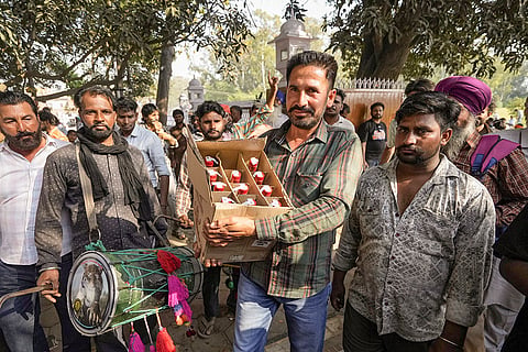 Devotees offer alchohol at Baba Rode Shah Mazar