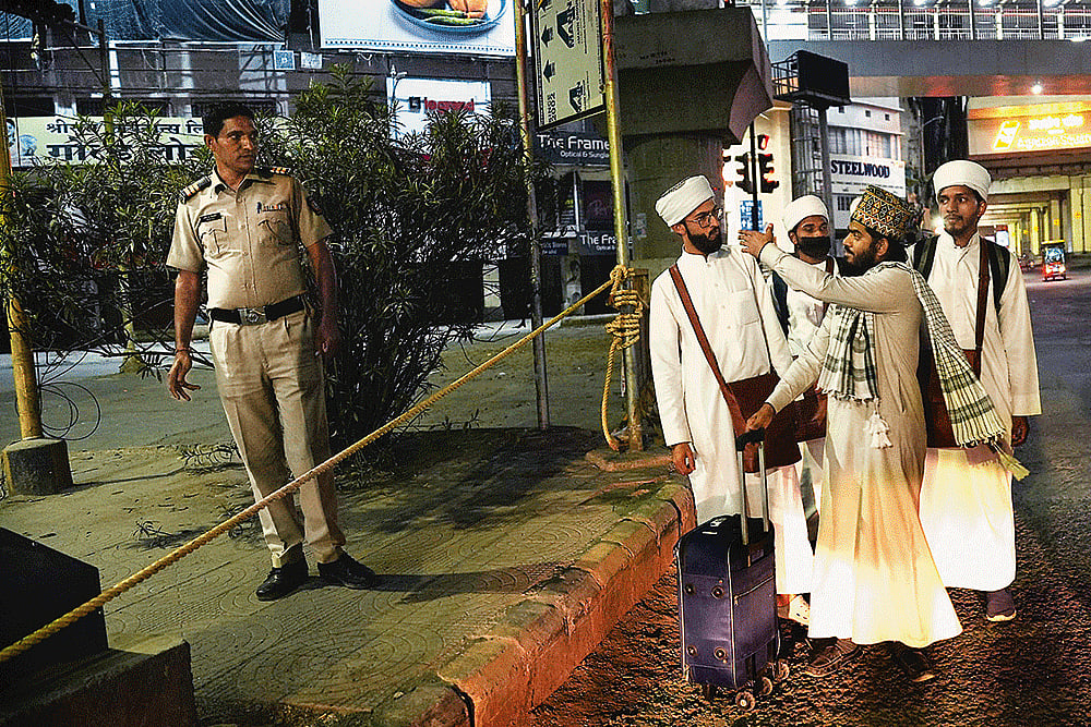A policeman stops a group of Muslim religious students from entering the curfewed area in Nagpur