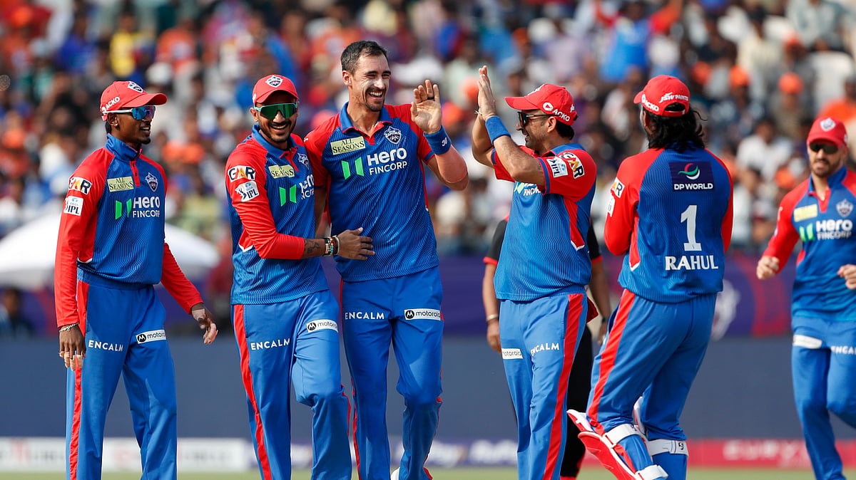 Delhi Capitals Mitchell Starc, center, celebrates the wicket. AP