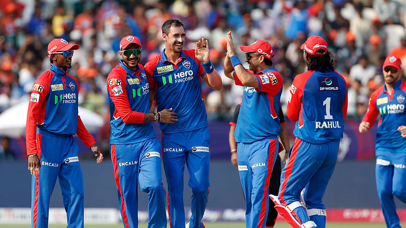 Delhi Capitals Mitchell Starc, center, celebrates the wicket. AP