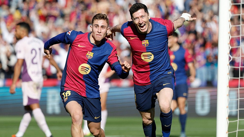 AP : Robert Lewandowski (right) celebrates his side's second goal with Fermin Lopez.