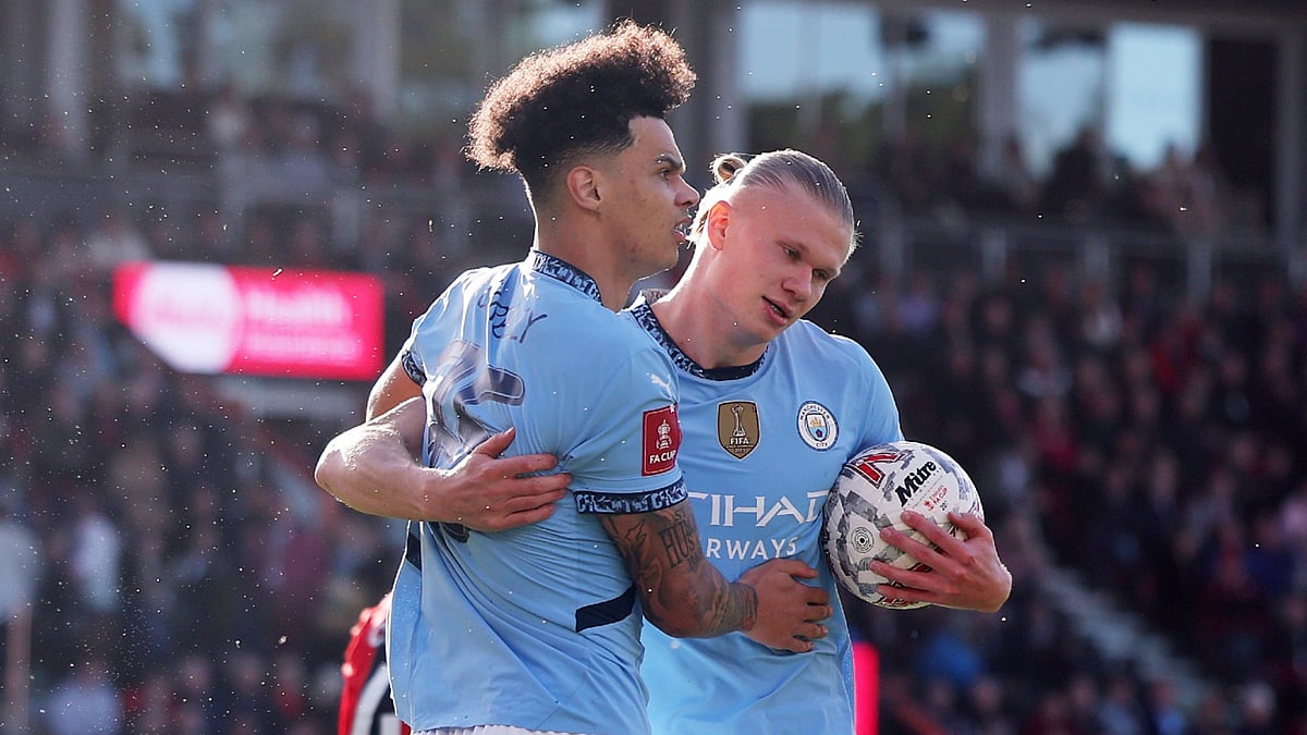 Nico O'Reilly celebrates with Erling Haaland