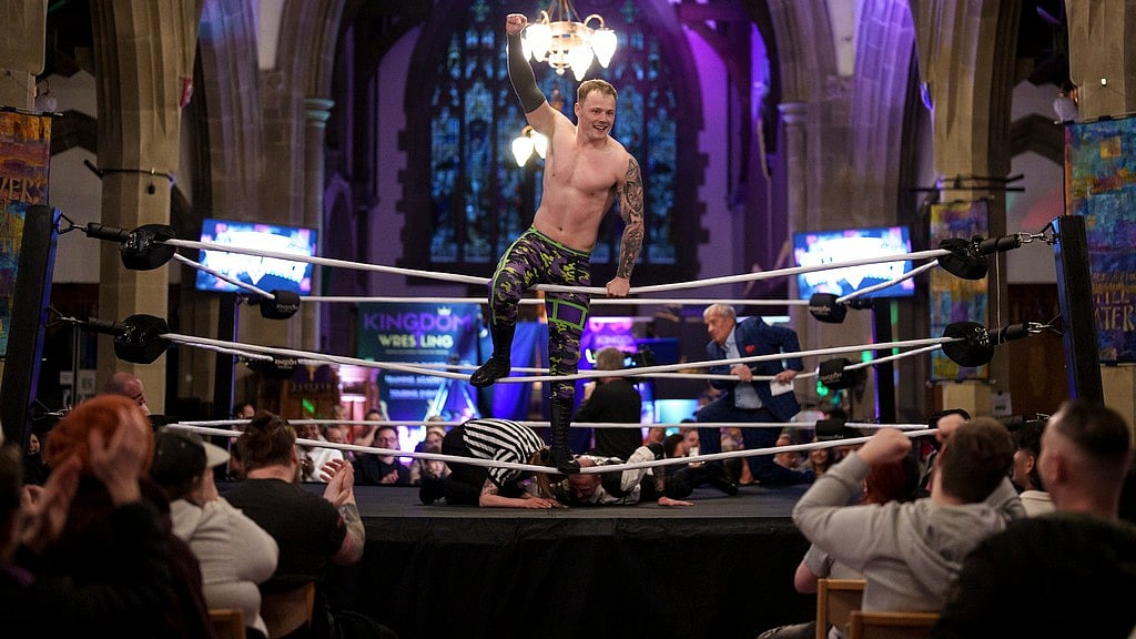 AP : Billy O'Keefe celebrates victory in a six-man-scramble at a Kingdom Wrestling show at St Peter's Church in Shipley.