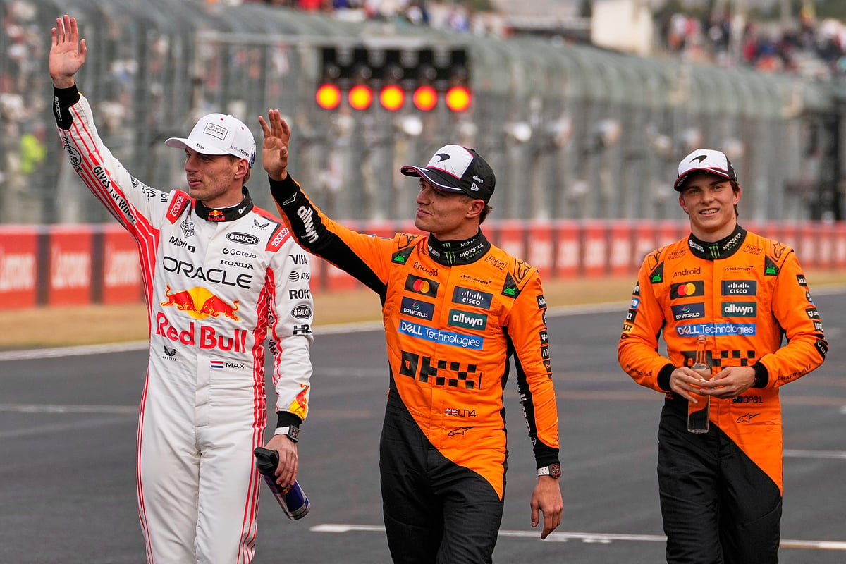 (AP Photo/Shuji Kajiyama)
   : Red Bull driver Max Verstappen of the Netherlands, left, is accompanied with McLaren driver Lando Norris of Britain, center, and McLaren driver Oscar Piastri of Australia, right, after qualifying session for the Japanese Formula One Grand Prix at the Suzuka Circuit in Suzuka, central Japan, Saturday, April 5, 2025. 
