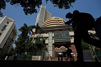 Coping With Donald Trump's Tariff Tantrums Photo: AP/Rafiq Maqbool : Office goers walk past the Bombay Stock Exchange building in Mumbai