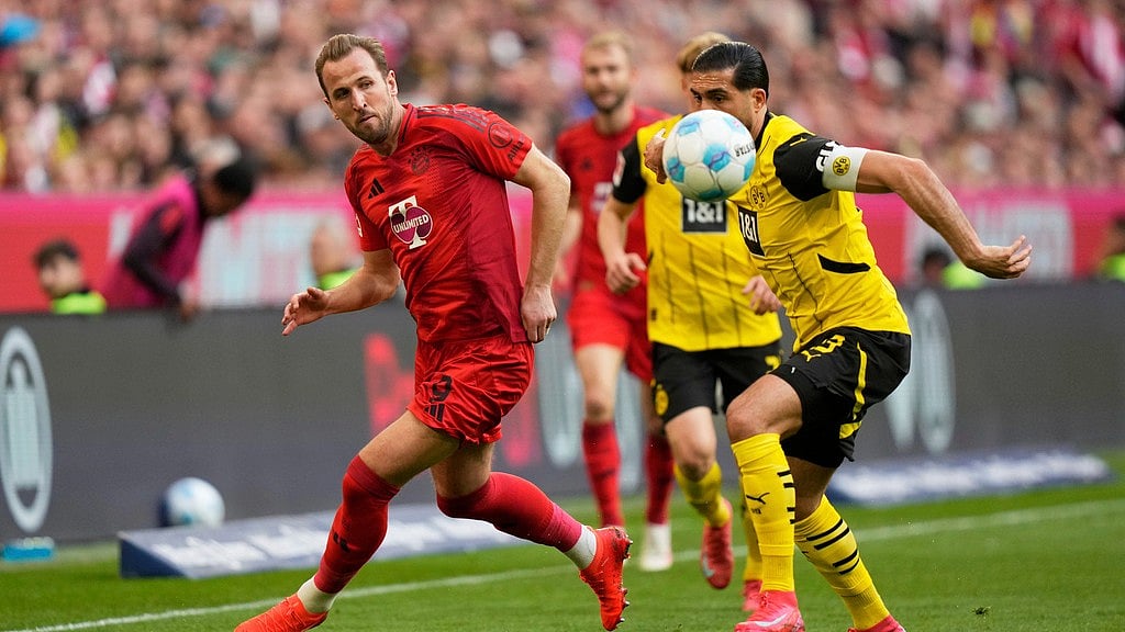 AP/Matthias Schrader : Harry Kane, left, challenges for the ball with Dortmund's Emre Can during the German Bundesliga soccer match