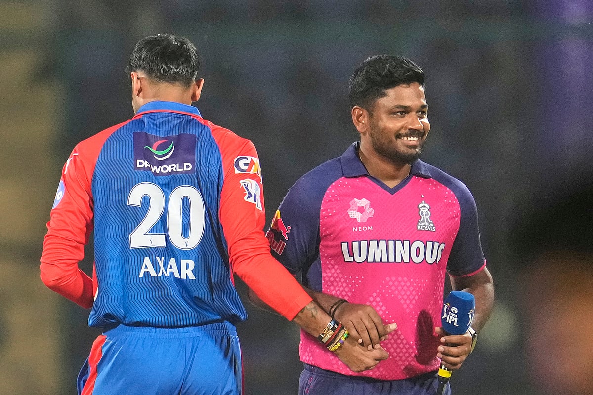 Delhi Capitals' captain Axar Patel and Rajasthan Royals' captain Sanju Samson share a lighter moment at the toss during the Indian Premier League cricket match between Delhi Capitals and Rajasthan Royals at Arun Jaitley stadium in New Delhi, India, Wednesday, April 16, 2025.