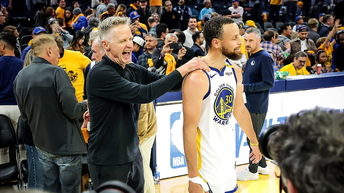 Steve Kerr celebrates with Stephen Curry - null