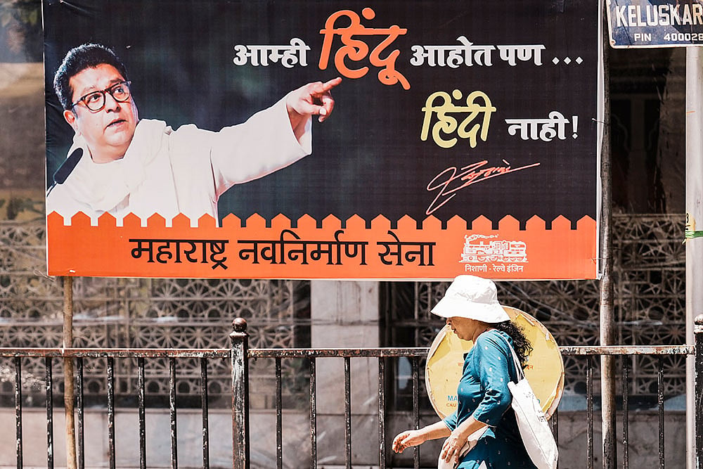 Photo: PTI/Kunal Patil : MNS poster near Shiv Sena Bhavan in Mumbai
